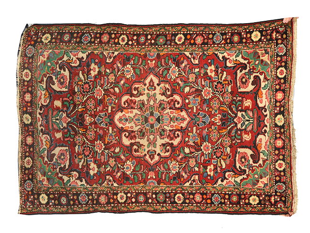 Appraisal: AN OLD HAMEDAN RED GROUND RUG with flower decoration to