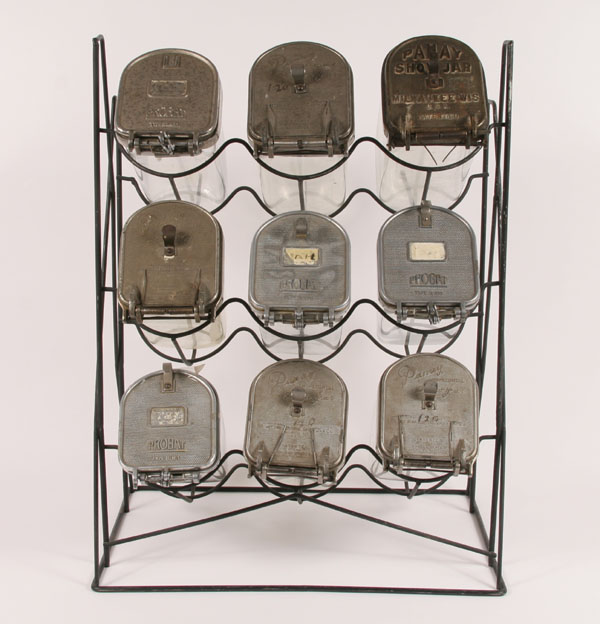 Appraisal: Nine large glass seed jars on iron rack Probat Panay