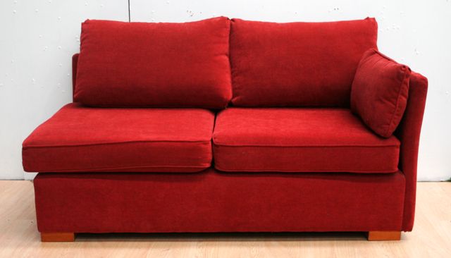 Appraisal: A modern red upholstered lounge suite comprising a three seater