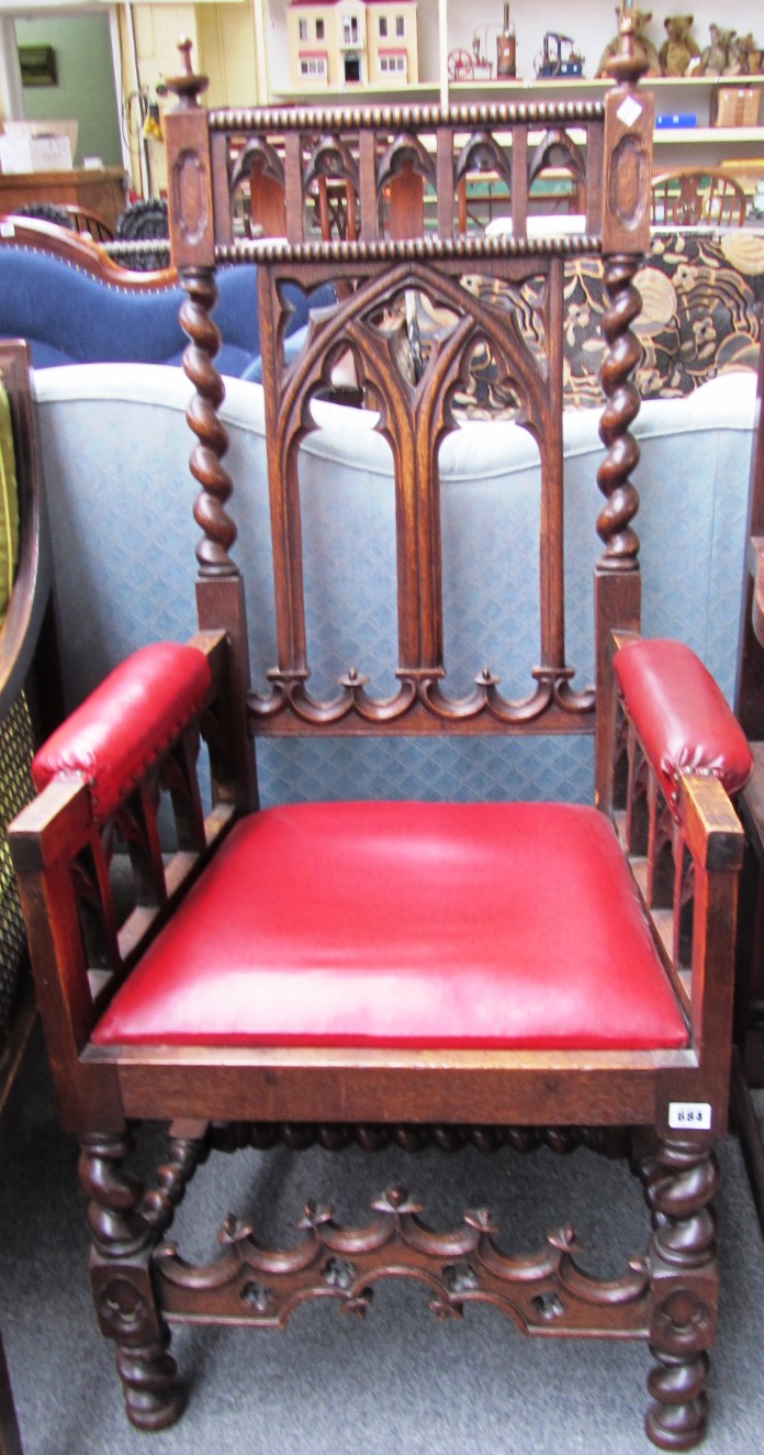 Appraisal: An oak framed Gothic Revival open armchair on barley-twist supports