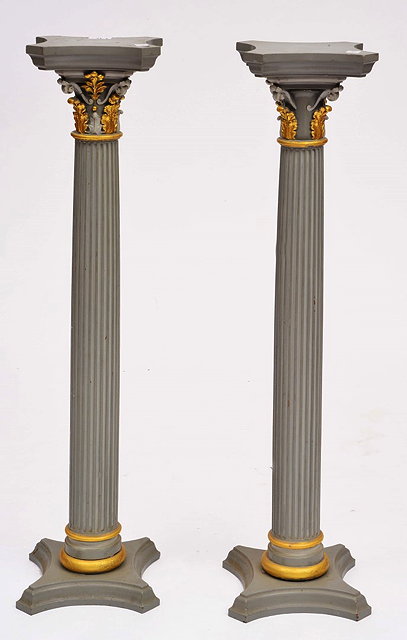 Appraisal: A PAIR OF GREY PAINTED FLUTED COLUMNS with gilt acanthus