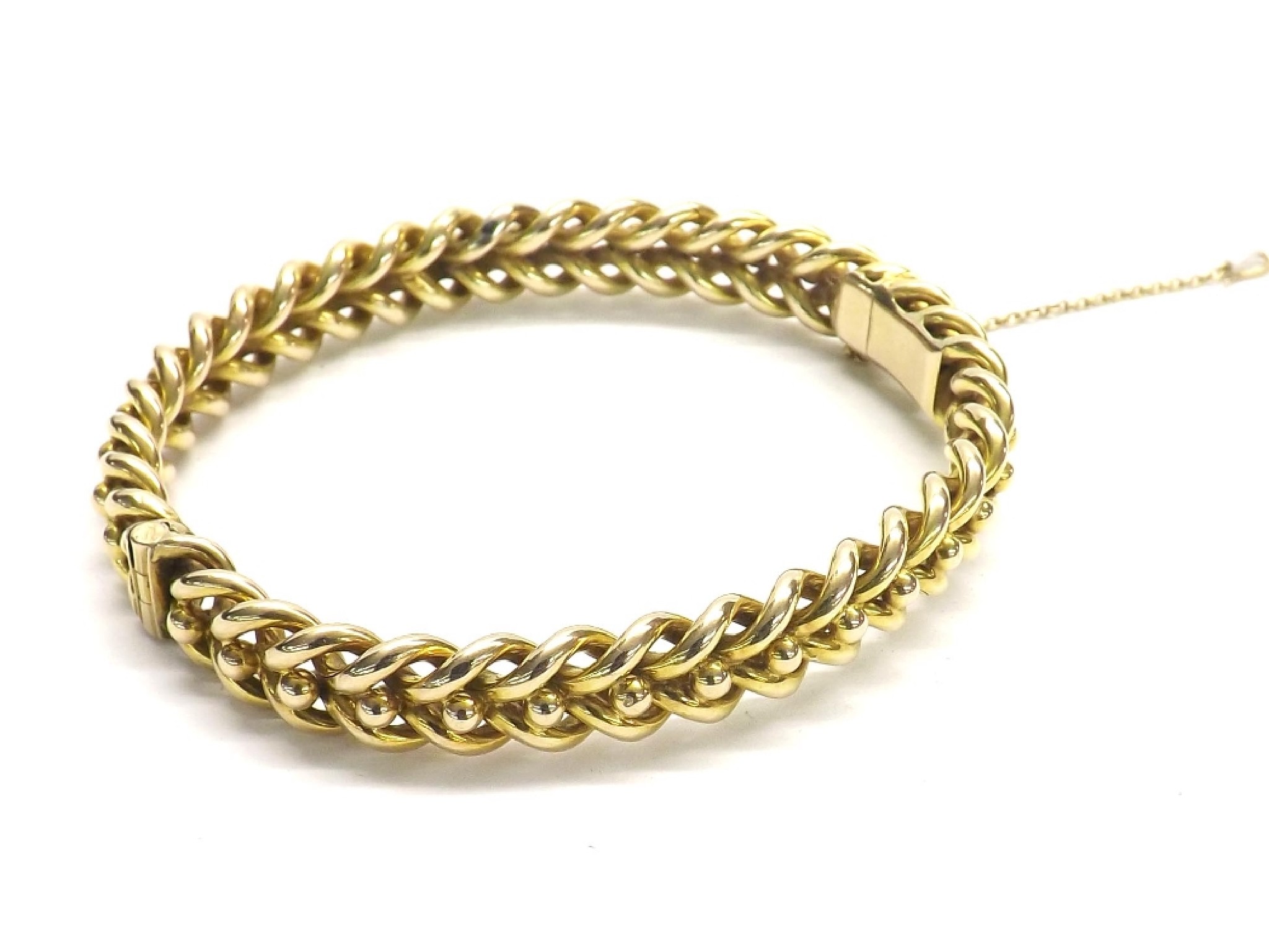 Appraisal: Yellow gold hinged bangle with entwined and bead links with