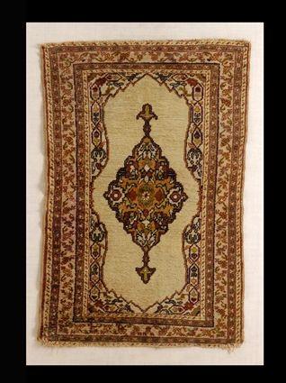 Appraisal: PERSIAN MEDALLION MAT The oblong wine red and salmon medallion