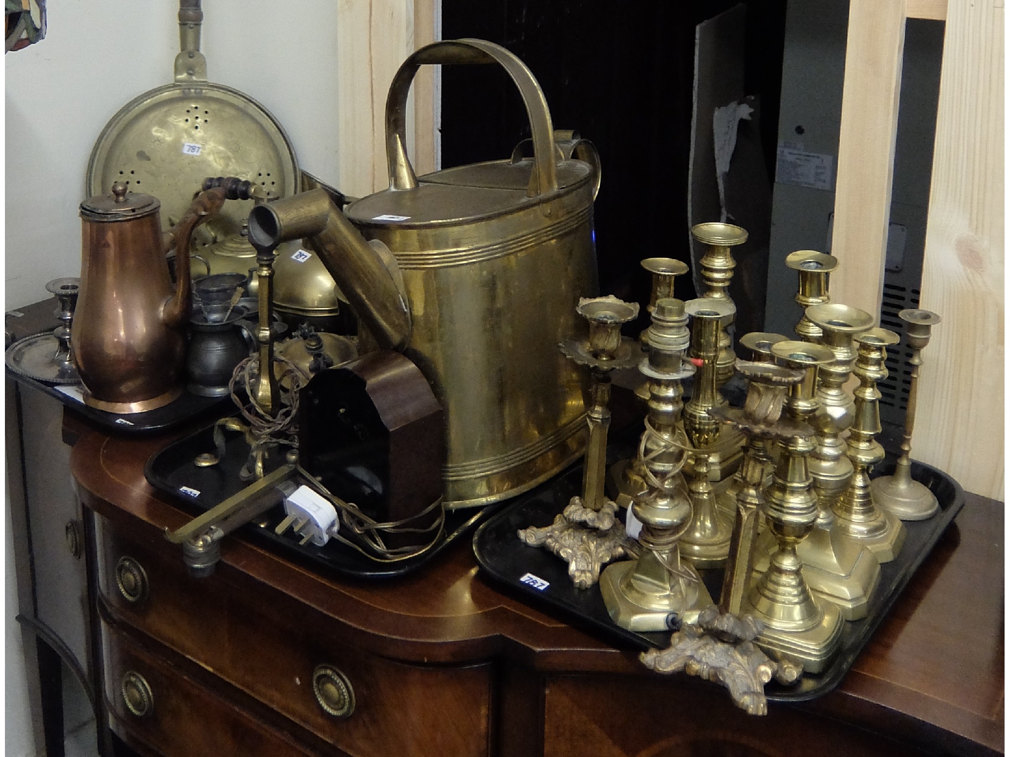 Appraisal: Three trays of brassware to include candlesticks water can bed