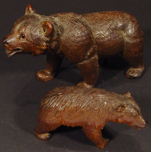 Appraisal: Two graduated Black Forest carved wooden bears each set with