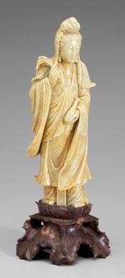 Appraisal: Chinese carved softstone Guanyin pale green with russet mottling reddish-brown