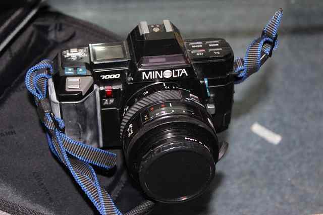 Appraisal: A MINOLTA SLR CAMERA together with a telephoto lens and