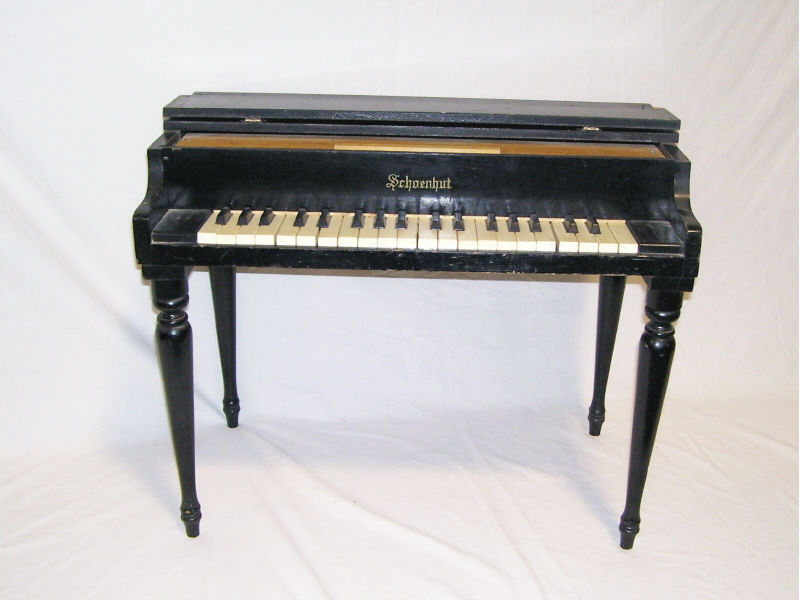 Appraisal: Schoennhut Piano Ebony wooden case and plastic keys Measures high