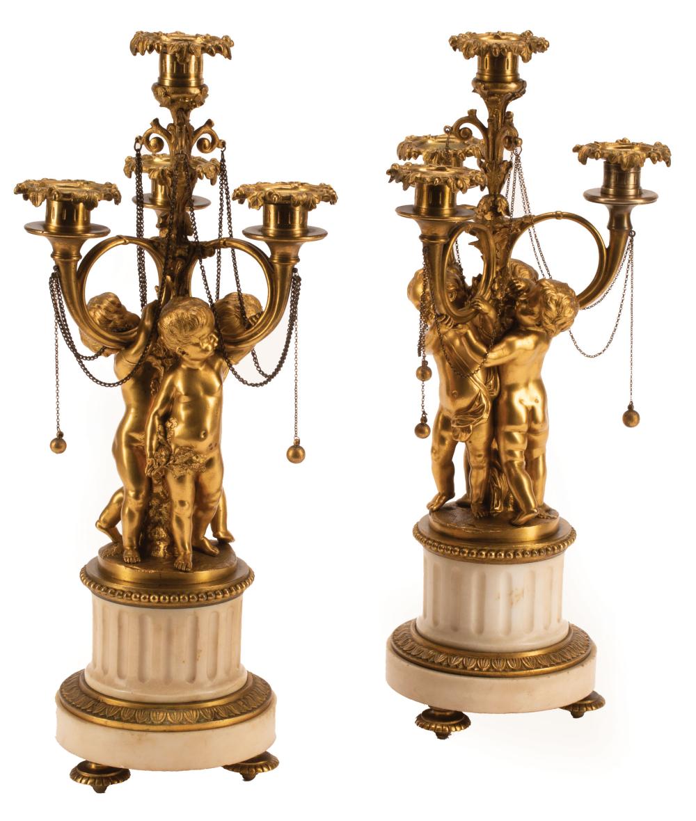 Appraisal: Pair of French Bronze and Marble Four-Light Candelabra c cherub