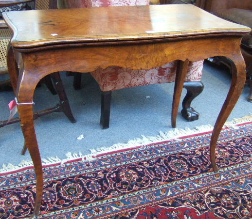 Appraisal: A Victorian walnut card table the serpentine foldover top over