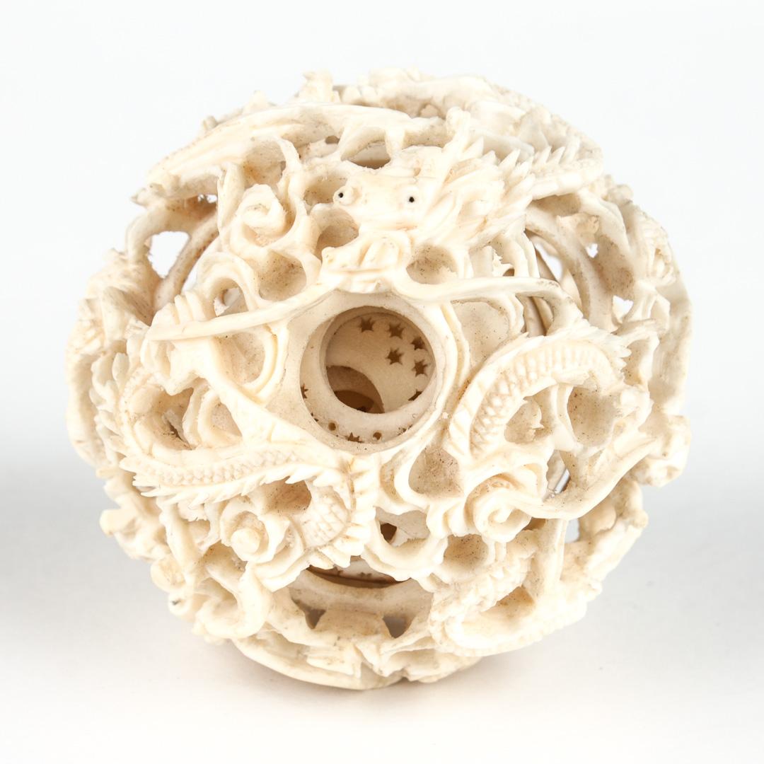 Appraisal: Chinese carved ivory puzzle ball modeled with entwined dragons approx