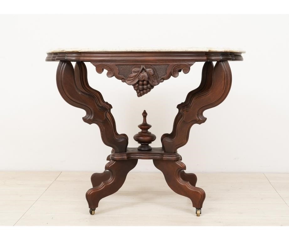 Appraisal: Victorian carved walnut parlor table with shaped oval top h