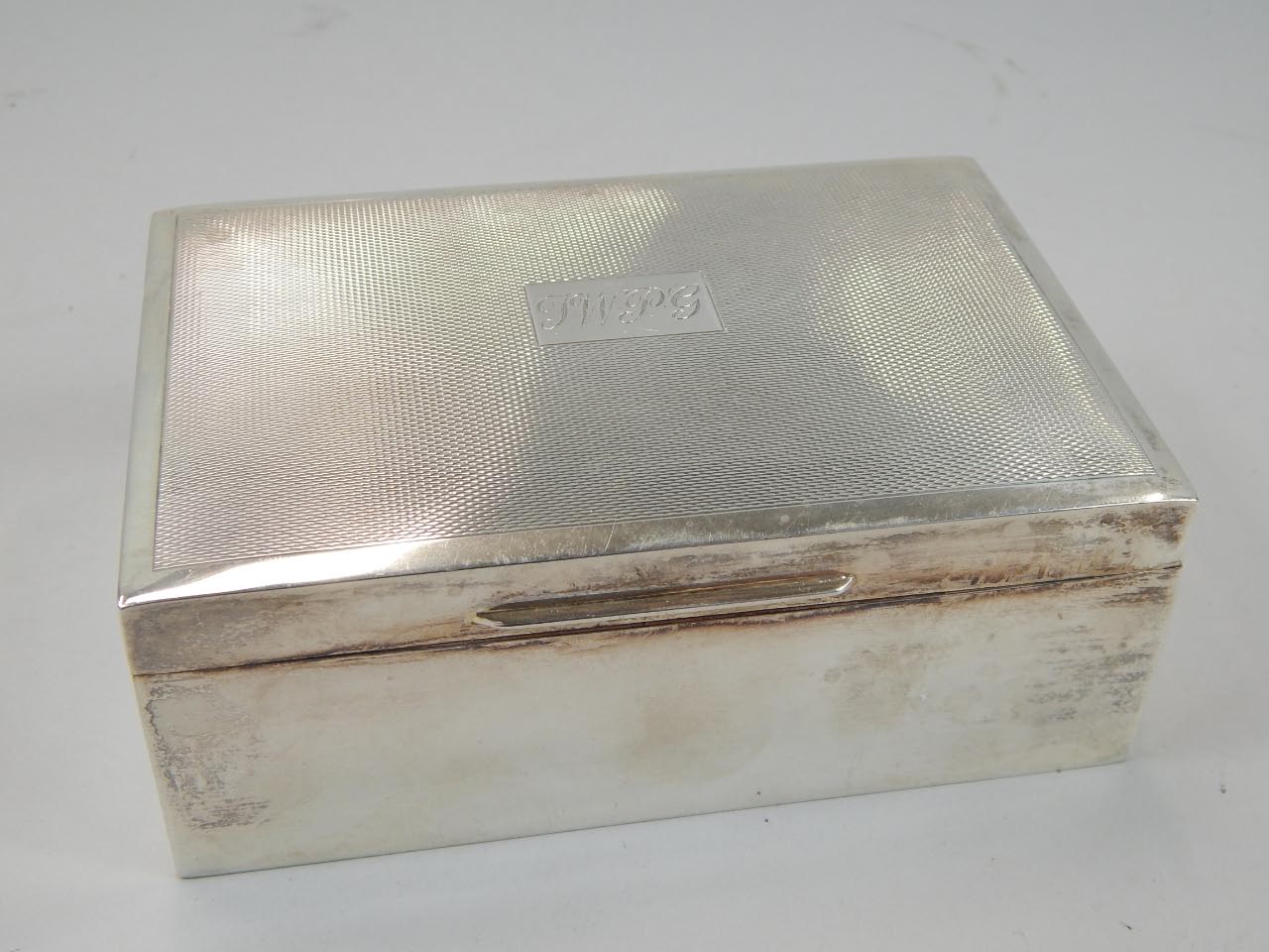 Appraisal: An Elizabeth II silver cigarette case the rectangular outline with