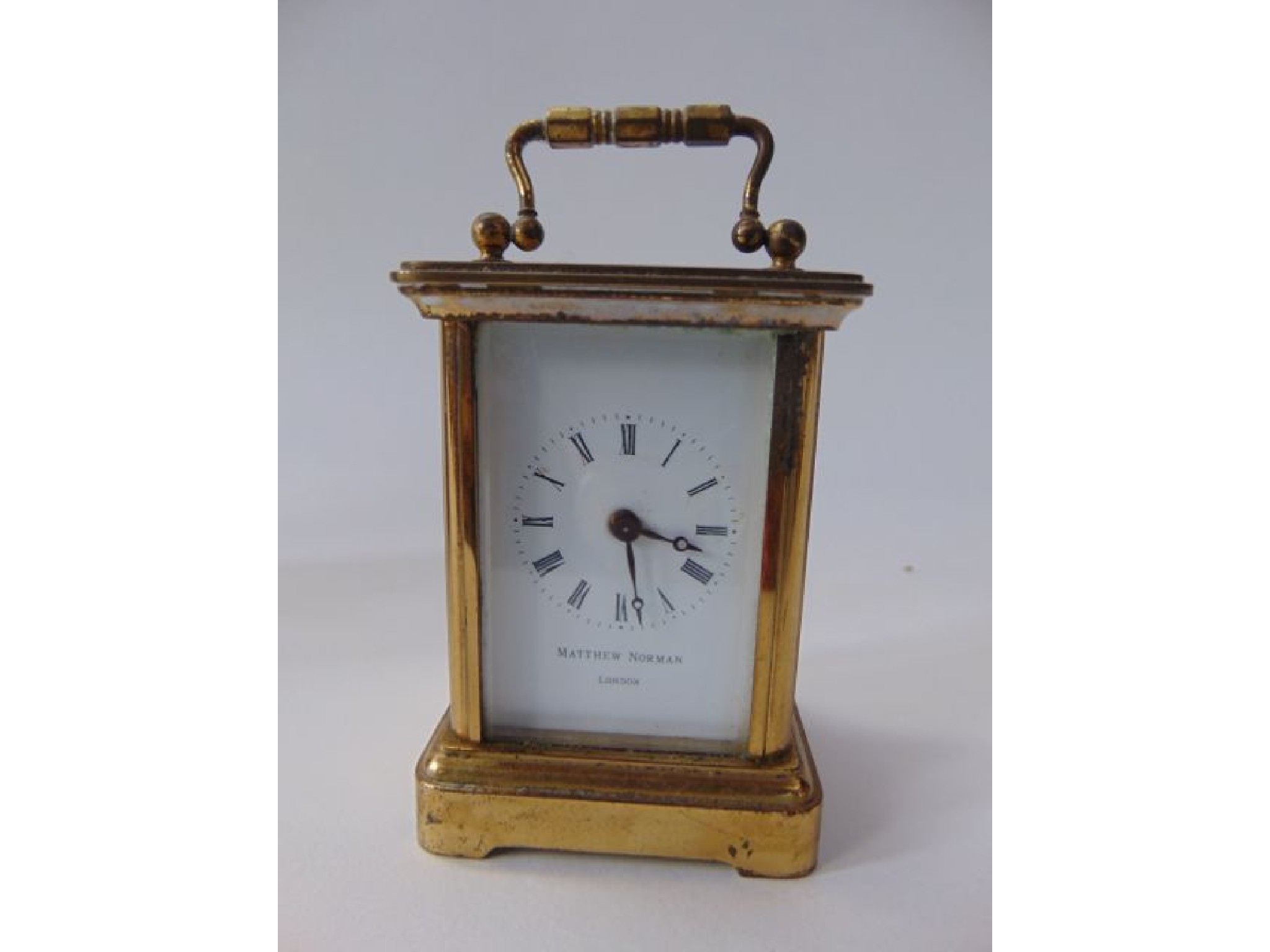 Appraisal: A miniature brass cased carriage clock with bevelled glazed panelled