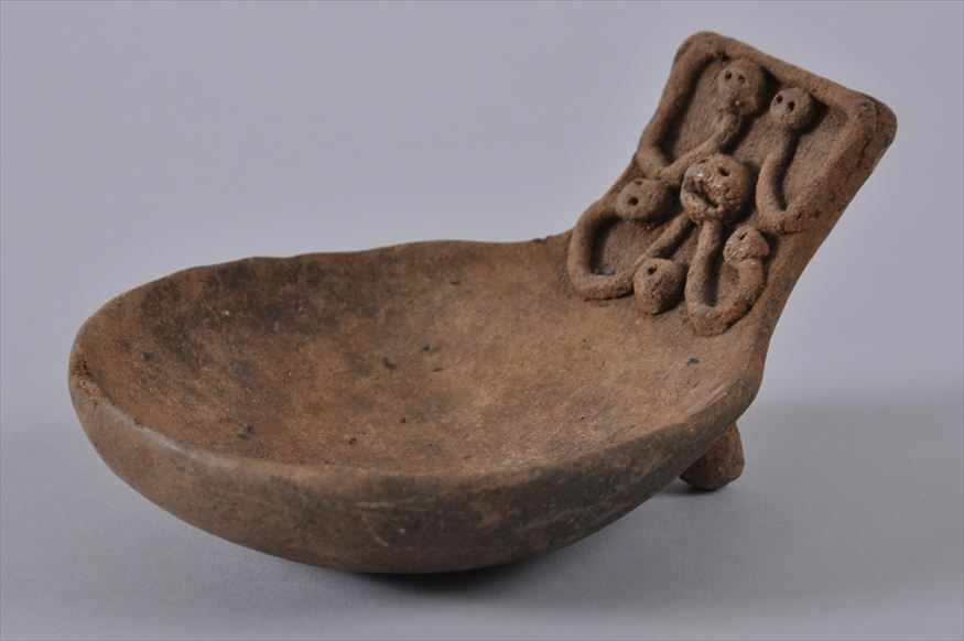 Appraisal: CHINESE TERRACOTTA CEREMONIAL SPOON The rectangular handle with applied serpent-formed