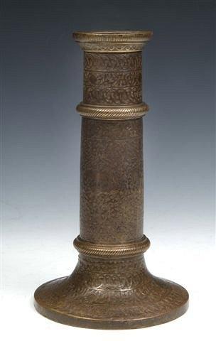 Appraisal: AN EARLY ISLAMIC METALWORK CANDLESTICK probably th Century engraved with