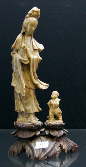 Appraisal: A hardstone figure of Guanyin and a boy on a