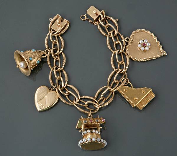 Appraisal: A k gold charm bracelet with five charms g gross