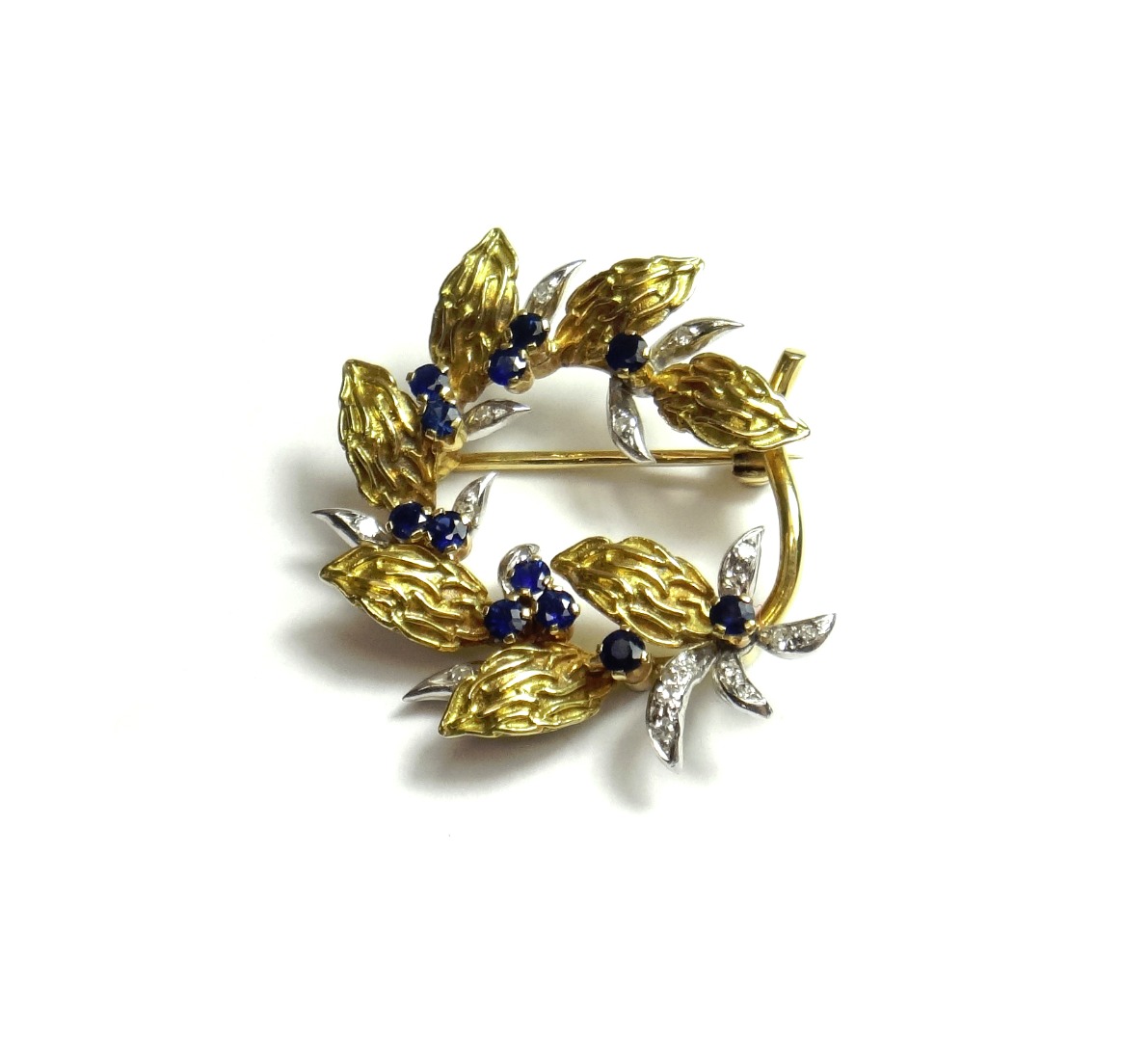 Appraisal: An ct two colour gold sapphire and diamond set brooch