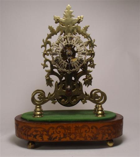 Appraisal: A th century brass skeleton clock of scrolled design on