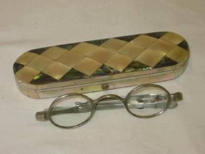 Appraisal: A PAIR OF GEORGIAN SPECTACLES the oval lenses on adjustable