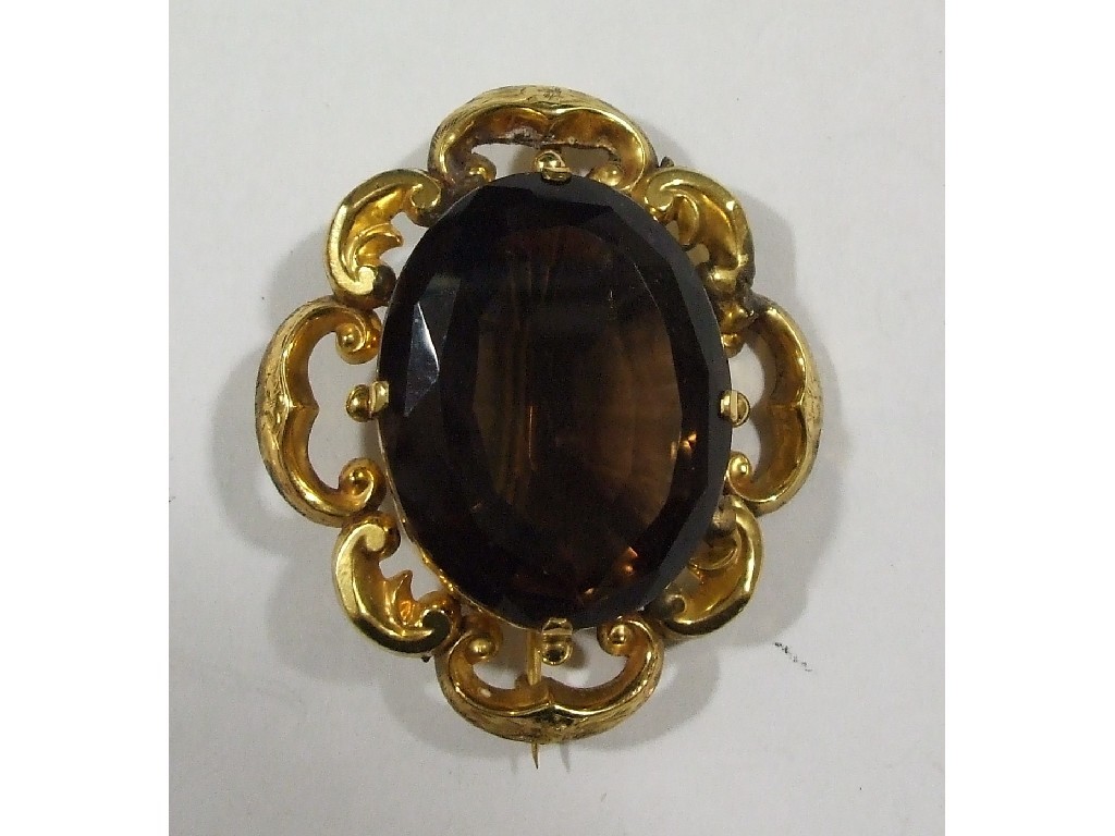 Appraisal: Victorian yellow metal scroll brooch with large smokey quartz inset