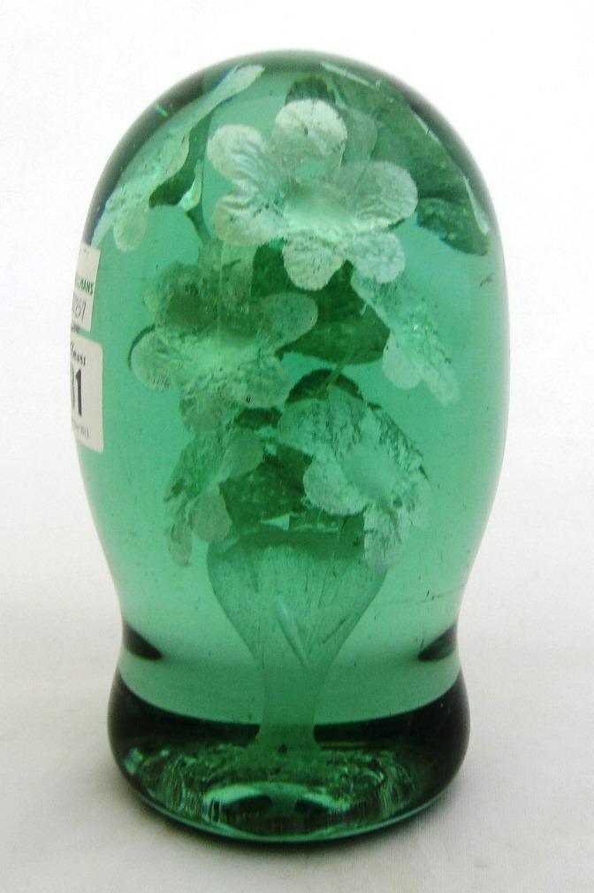 Appraisal: A Victorian green glass dump paperweight with floral inclusion cm