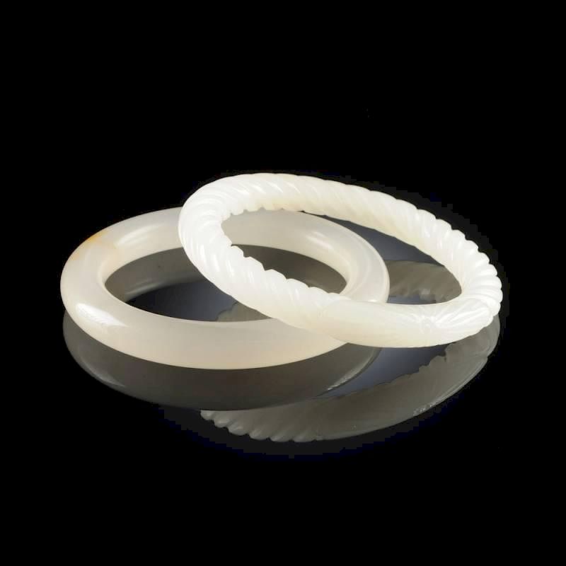 Appraisal: A GROUP OF TWO CHINESE WHITE JADE BANGLES MODERN A