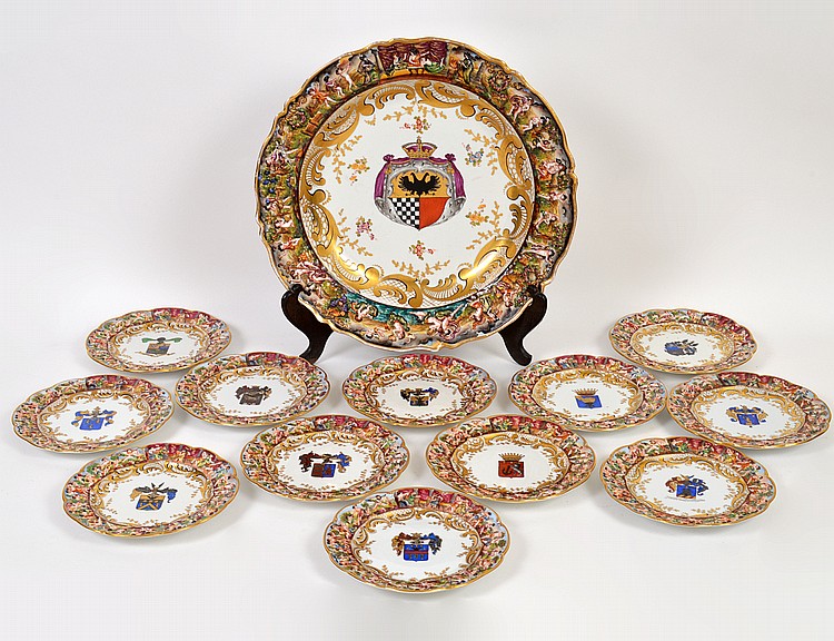 Appraisal: CAPODIMONTE ARMORIAL PORCELAIN CHARGER TWELVE PLATESEarly th Century The underside