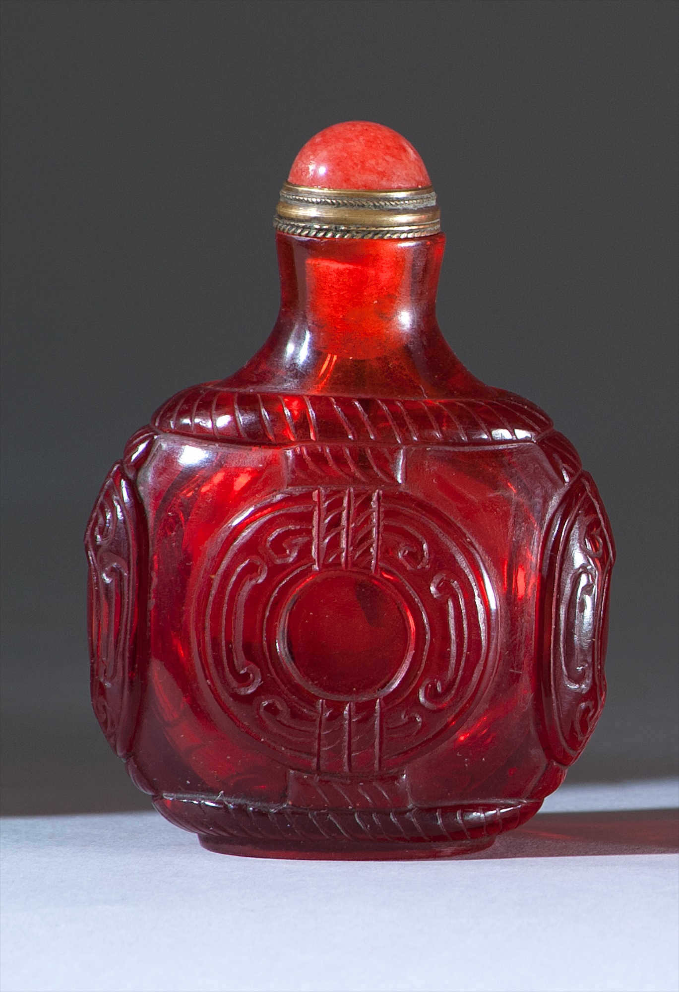 Appraisal: RUBY GLASS SNUFF BOTTLE th CenturyIn ovoid form with coin