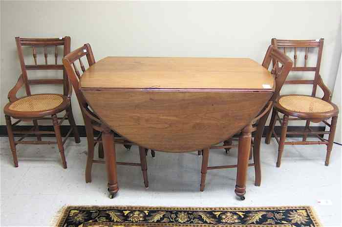 Appraisal: A VICTORIAN WALNUT DINING TABLE AND FOUR CHAIRS American last