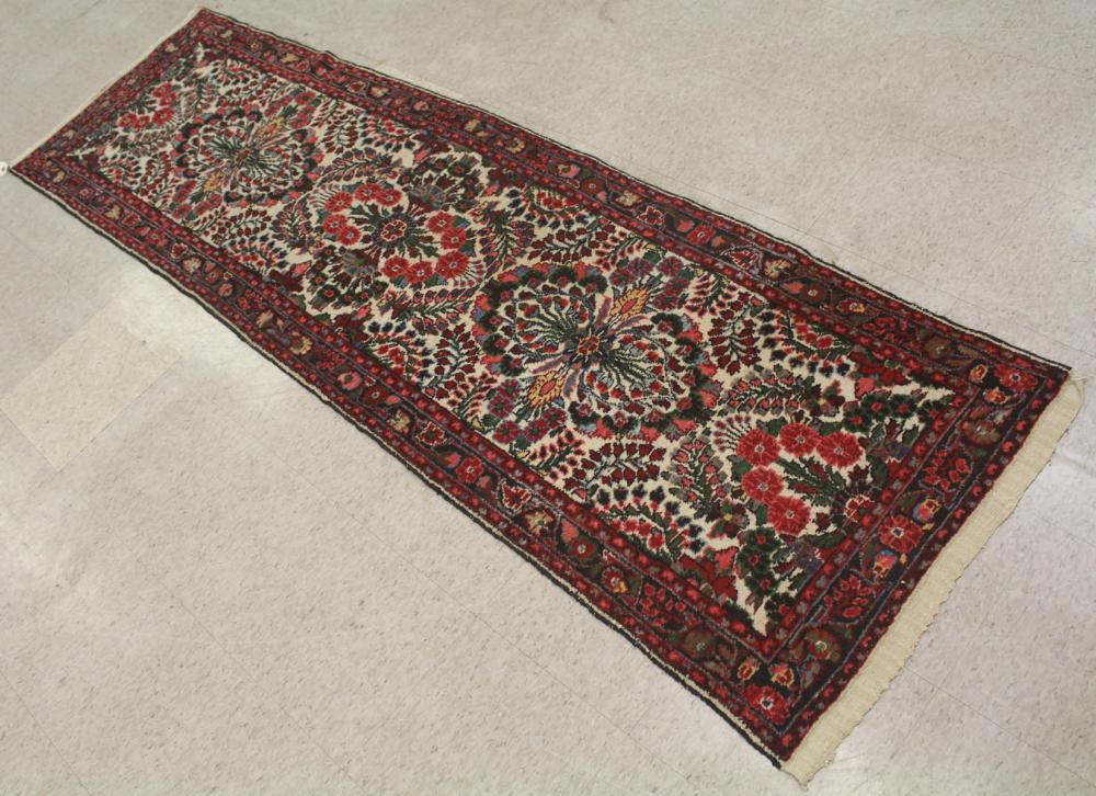 Appraisal: SEMI-ANTIQUE PERSIAN RUNNER floral design on cream ground hand knotted