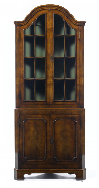 Appraisal: A WALNUT CORNER CABINET the arched moulded top above a