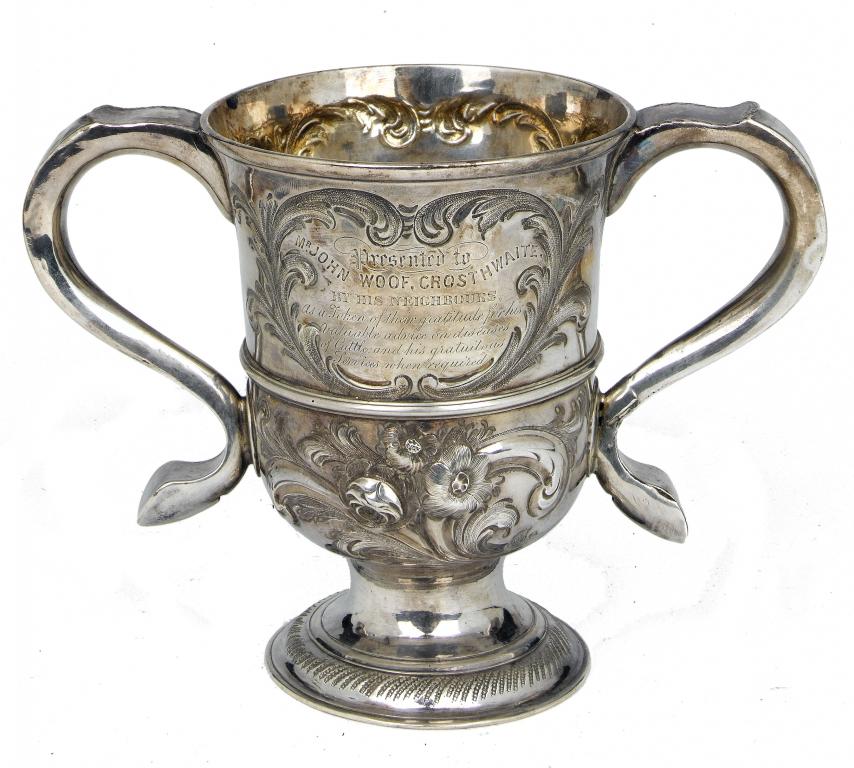 Appraisal: A GEORGE II TWO HANDLED CUP with moulded girdle on