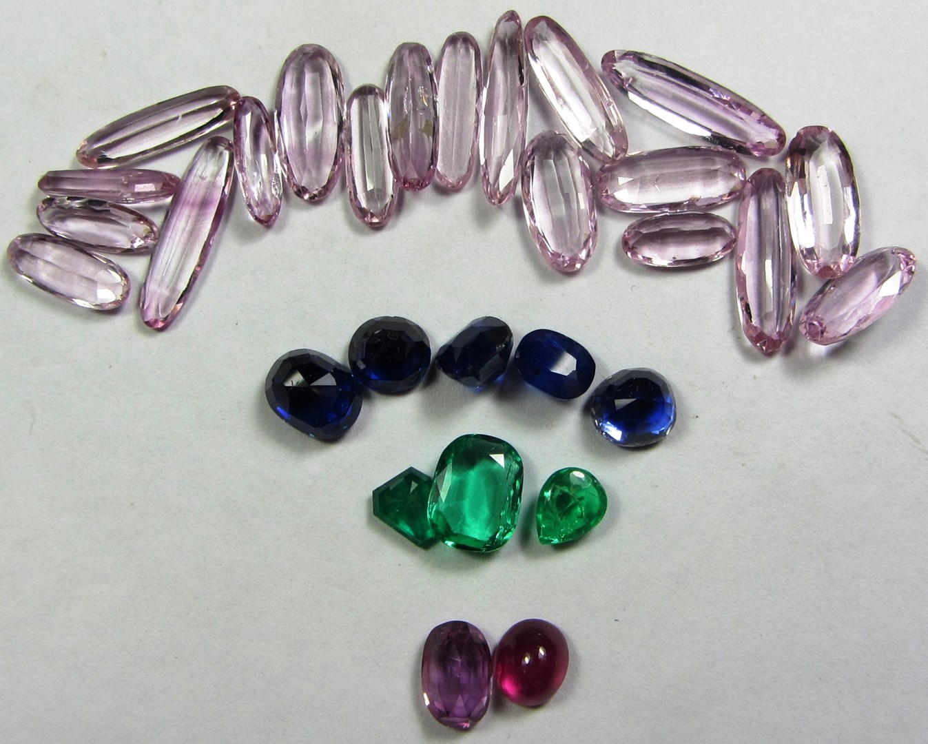 Appraisal: A collection of unmounted gemstones comprising pink topaz an emerald