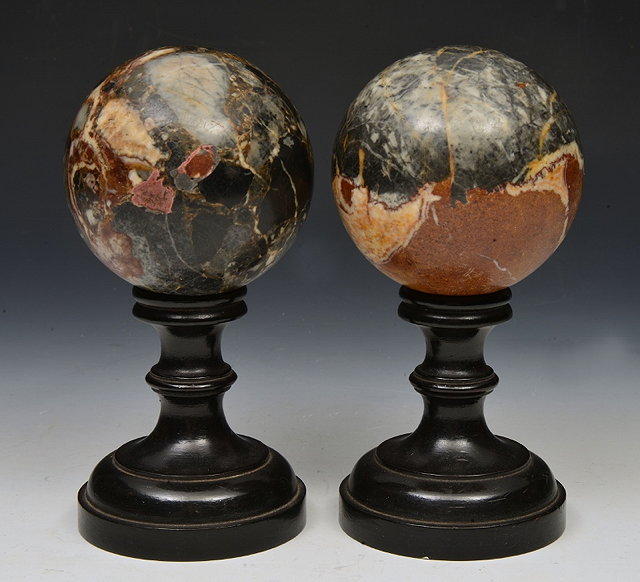 Appraisal: A PAIR OF MARBLE SPHERES of variegated form on turned