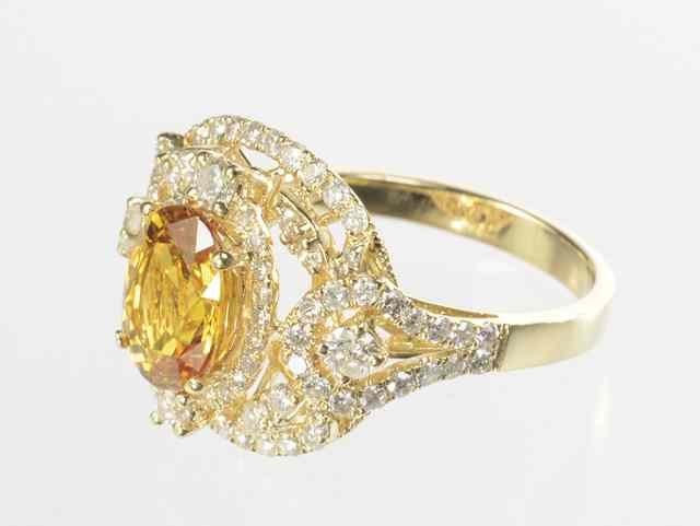 Appraisal: ORANGE SAPPHIRE AND DIAMOND RING k yellow gold with round-cut