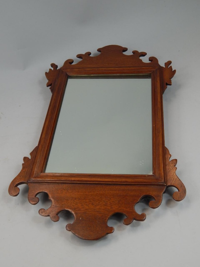 Appraisal: A mahogany fret frame wall mirror in George III style