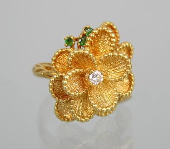 Appraisal: An k Gold Flower Form Ring with Emeralds and a