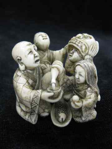 Appraisal: Carved Ivory Group Figurine of Family eating drinking child with