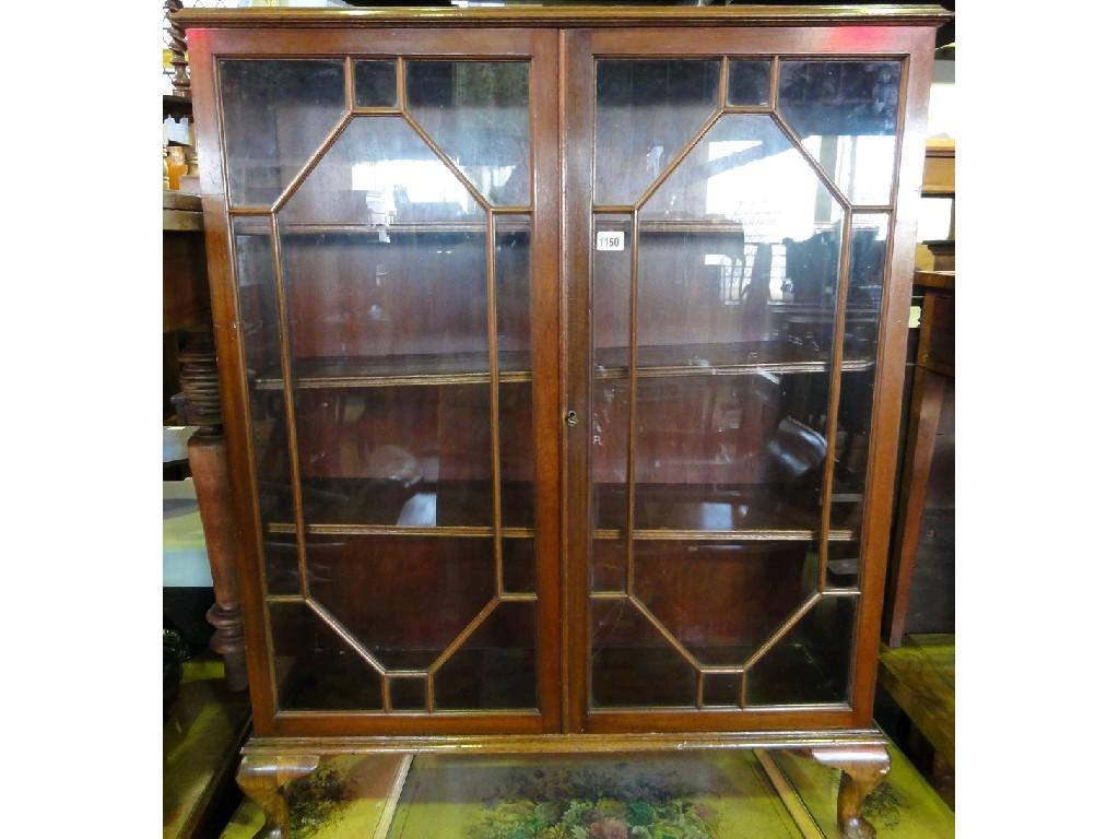 Appraisal: An Edwardian mahogany bookcase enclosed by a pair of astragal