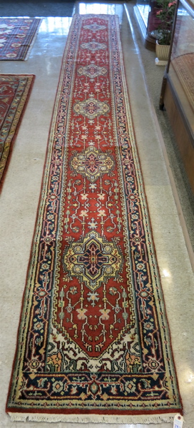 Appraisal: HAND KNOTTED ORIENTAL LONG RUG Persian Serapi design of repeating