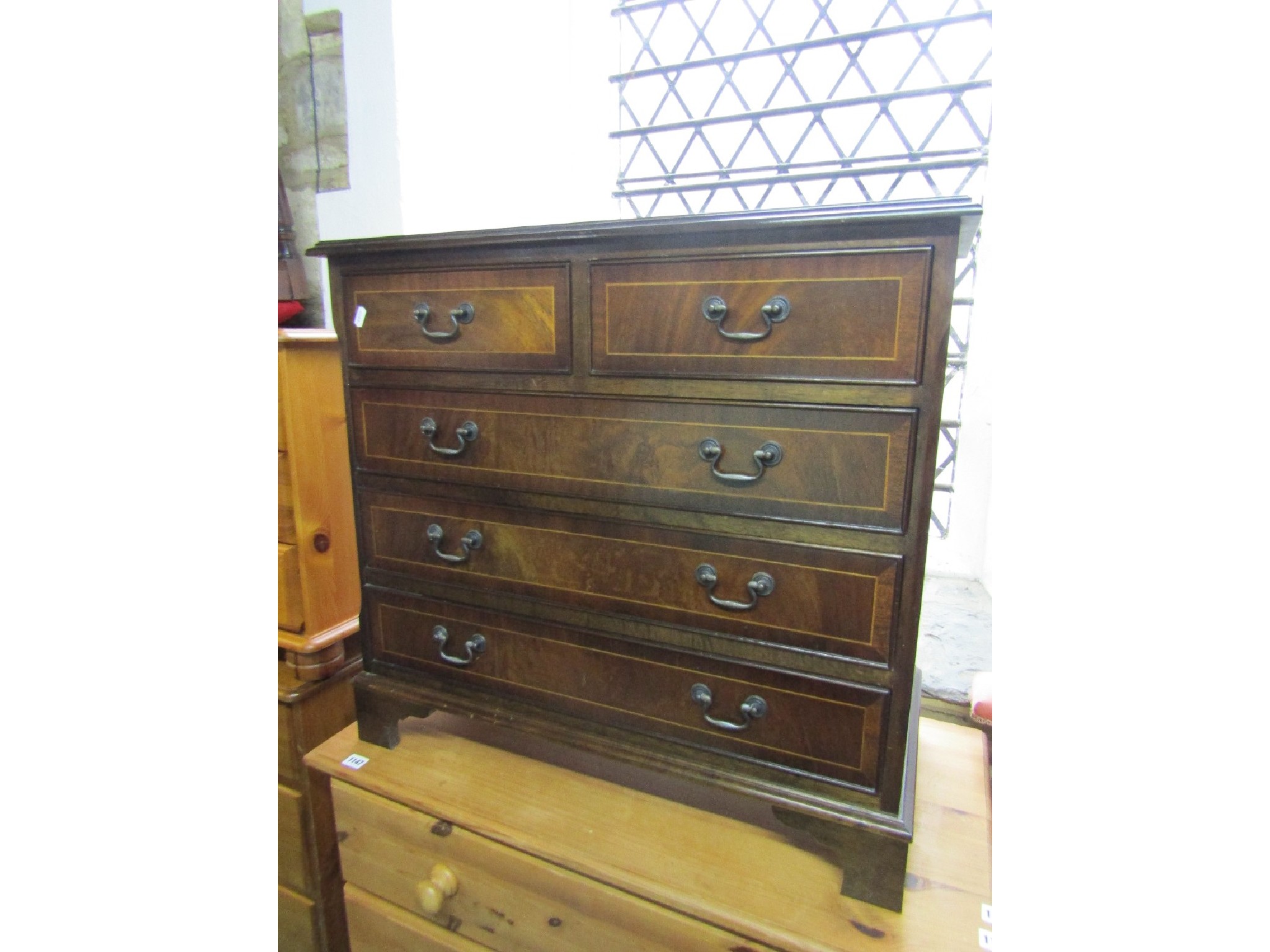 Appraisal: A small reproduction mahogany veneered bedroom chest in the Georgian