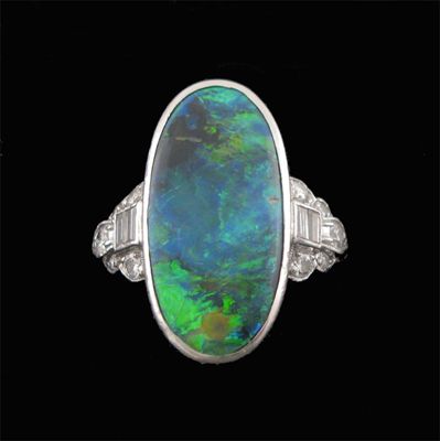 Appraisal: An opal and diamond ring by Caldwell the oval shaped