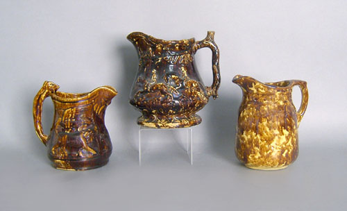 Appraisal: Three Rockingham glaze pitchers one with hound handle h h