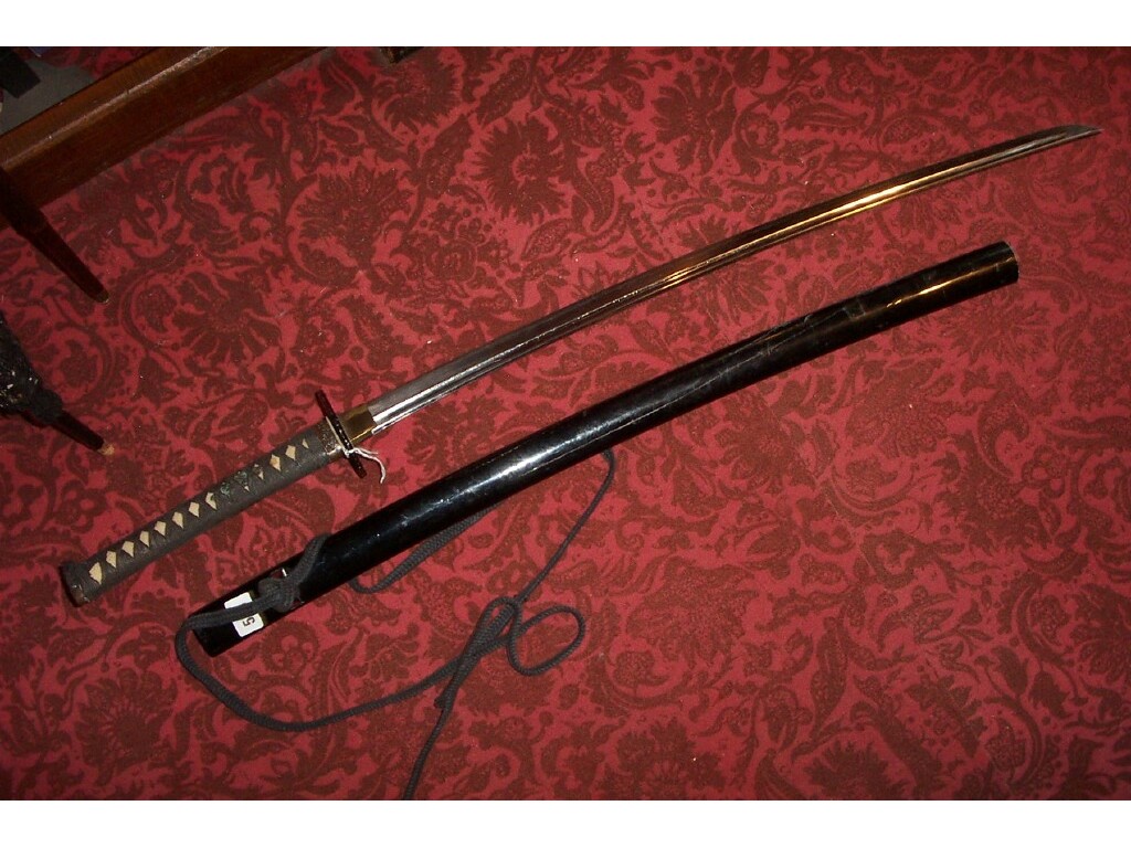 Appraisal: A Japanese sword with embossed dragon mount to the hilt