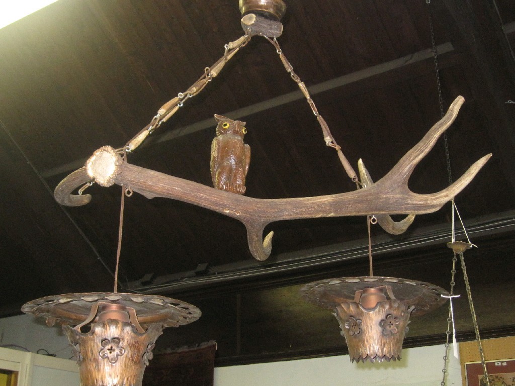 Appraisal: Antler ceiling light mounted with a carved owl figure and