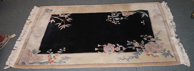 Appraisal: A CHINESE LARGE RUG with central black ground panel with