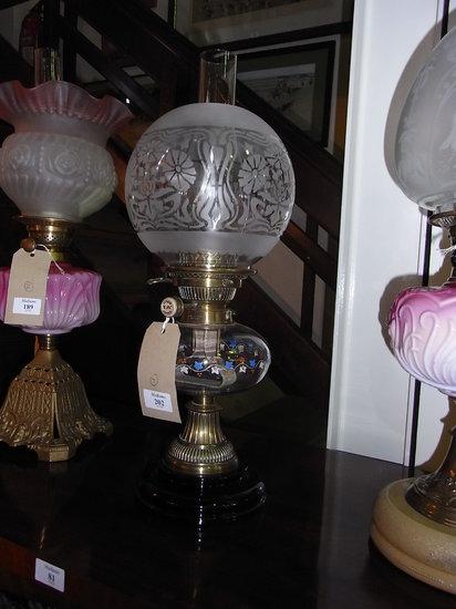 Appraisal: A VICTORIAN OIL LAMP with floral etched glass globe shade