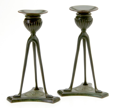 Appraisal: TIFFANY STUDIOS Pair of bronze tripod candlesticks with gadrooned cups